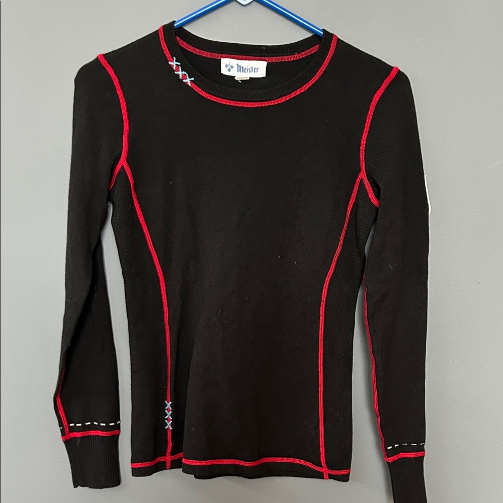 Meister Black Long Sleeve Top with Red Trim and embellishment.